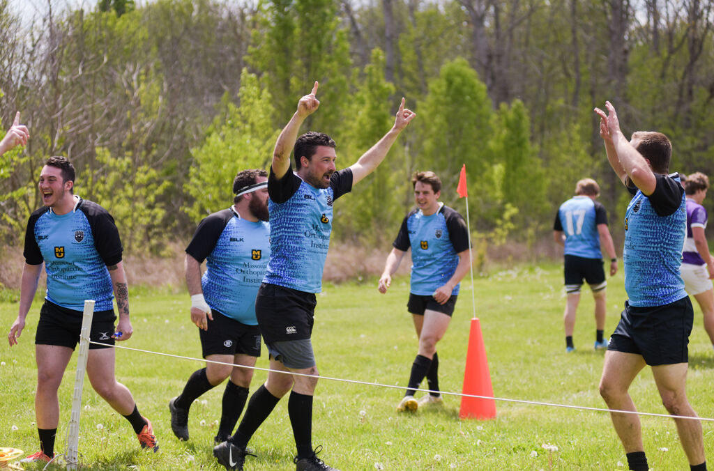 Columbia Outlaws's wing Jason Jacobs, center, celebrates with fullback Dakota Smith after scoring